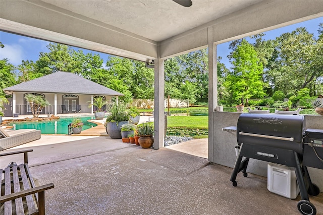 11 Turtle Cove Ct, Kingwood, TX 77346 - view of patio with an outdoor pool, an outbuilding, and view of scattered trees