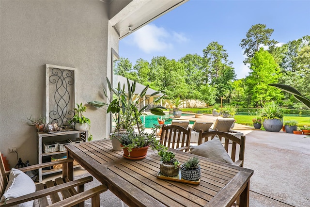 11 Turtle Cove Ct, Kingwood, TX 77346 - view of patio with outdoor dining space and an outdoor pool