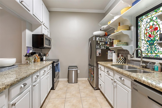 11 Turtle Cove Ct, Kingwood, TX 77346 - kitchen featuring appliances with stainless steel finishes, a sink, decorative backsplash, white cabinetry, and crown molding