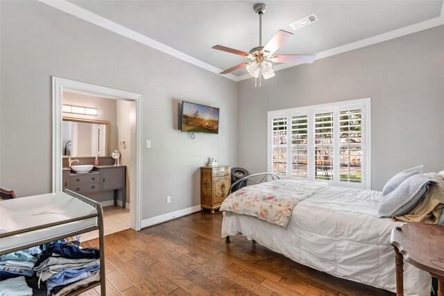 11 Turtle Cove Ct, Kingwood, TX 77346 - bedroom featuring ornamental molding, wood finished floors, baseboards, ceiling fan, and ensuite bathroom