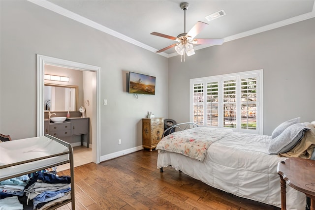 11 Turtle Cove Ct, Kingwood, TX 77346 - bedroom with ornamental molding, wood finished floors, baseboards, ceiling fan, and connected bathroom