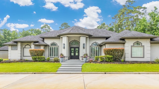 11 Turtle Cove Ct, Kingwood, TX 77346 - french country style house with french doors, stucco siding, and a front yard