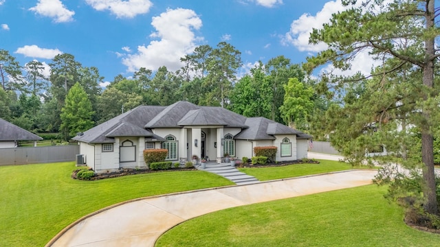 11 Turtle Cove Ct, Kingwood, TX 77346 - view of front facade featuring stucco siding and central AC