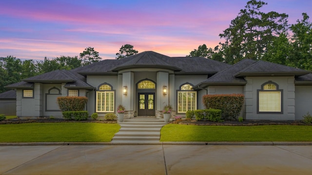 11 Turtle Cove Ct, Kingwood, TX 77346 - french country style house featuring french doors, stucco siding, and a front lawn