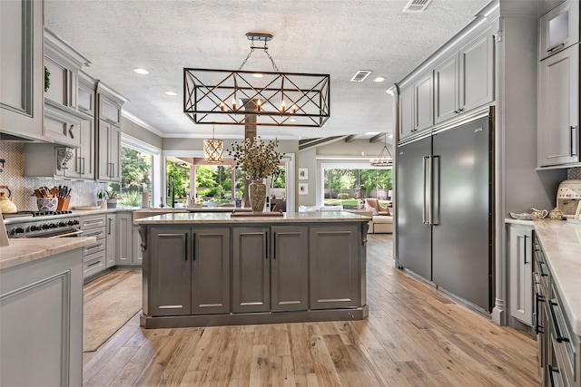 11 Turtle Cove Ct, Kingwood, TX 77346 - kitchen featuring stainless steel built in refrigerator, gray cabinets, light wood-style flooring, recessed lighting, and a chandelier