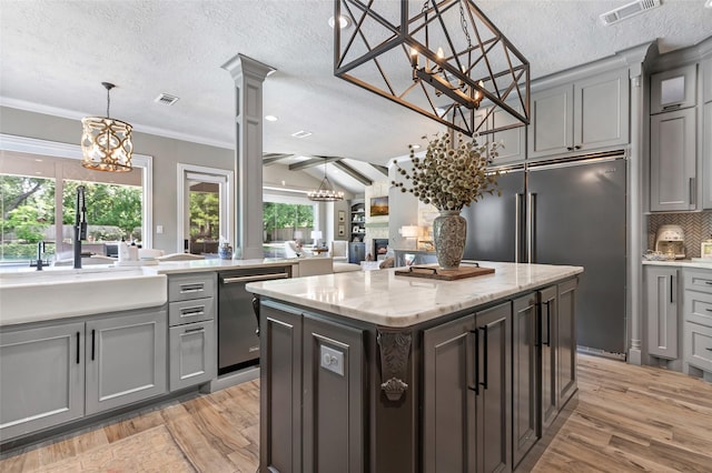 11 Turtle Cove Ct, Kingwood, TX 77346 - kitchen featuring a chandelier, stainless steel appliances, gray cabinets, light wood-type flooring, and a textured ceiling