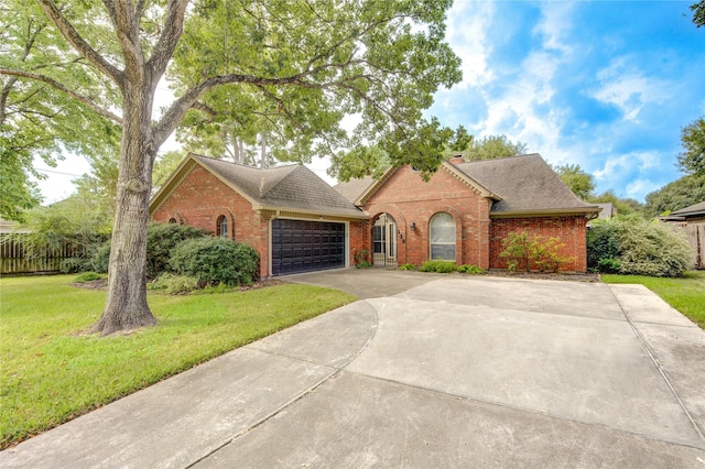 538 Everington Dr, Katy, TX 77450 - view of front facade with brick siding, concrete driveway, a garage, a front yard, and a shingled roof