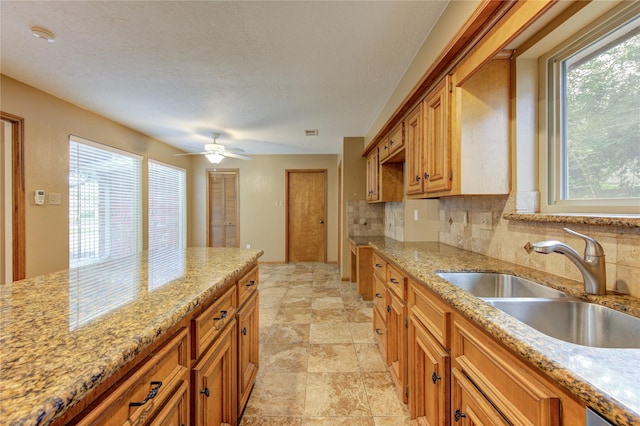 538 Everington Dr, Katy, TX 77450 - kitchen featuring a sink, tasteful backsplash, plenty of natural light, and a textured ceiling