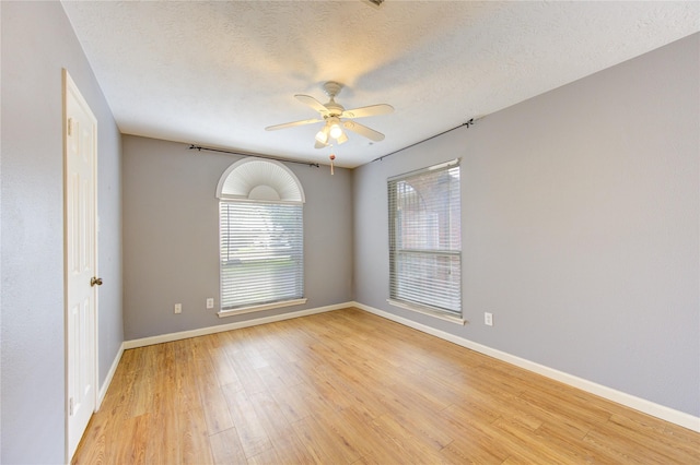 538 Everington Dr, Katy, TX 77450 - unfurnished room with healthy amount of natural light, light wood-style floors, a ceiling fan, baseboards, and a textured ceiling