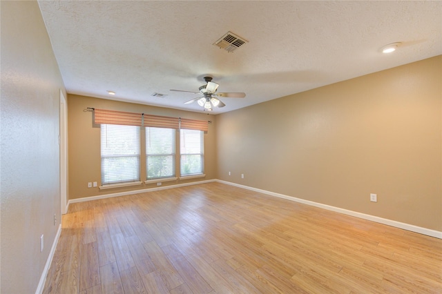 538 Everington Dr, Katy, TX 77450 - empty room featuring ceiling fan, light wood finished floors, baseboards, and a textured ceiling