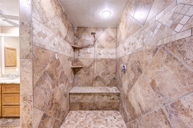 538 Everington Dr, Katy, TX 77450 - bathroom featuring tiled shower, a textured ceiling, and vanity