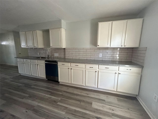 3914 Porter St, Houston, TX 77021 - kitchen featuring dishwashing machine, a sink, white cabinets, dark wood-style flooring, and backsplash