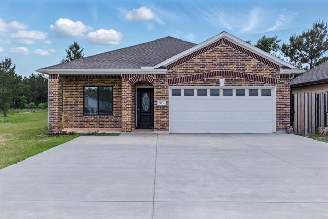 953 Rd 5606, Cleveland, TX 77327 - ranch-style house with brick siding, driveway, a garage, roof with shingles, and a front yard