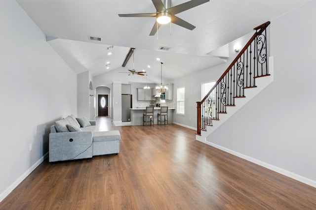 953 Rd 5606, Cleveland, TX 77327 - living area featuring a ceiling fan, arched walkways, dark wood-style flooring, baseboards, and lofted ceiling