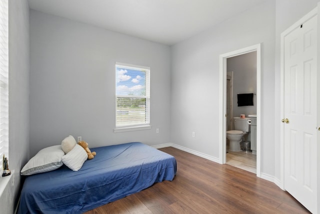953 Rd 5606, Cleveland, TX 77327 - bedroom featuring wood finished floors, baseboards, and ensuite bathroom