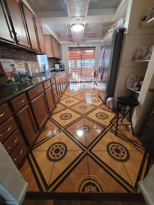 2013 Deats Rd, Dickinson, TX 77539 - kitchen featuring stainless steel refrigerator with ice dispenser, light tile patterned floors, dark countertops, and decorative backsplash