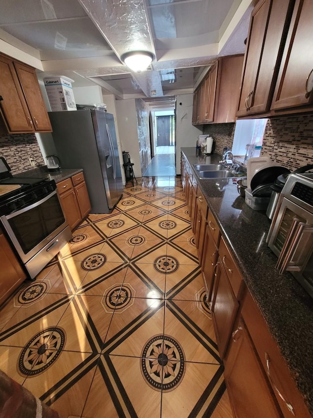 2013 Deats Rd, Dickinson, TX 77539 - kitchen with appliances with stainless steel finishes, a sink, light tile patterned floors, and tasteful backsplash