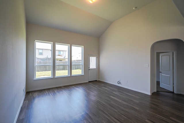 10314 White Fir Villa Ave, Houston, TX 77044 - unfurnished room featuring dark wood-type flooring, arched walkways, lofted ceiling, and baseboards