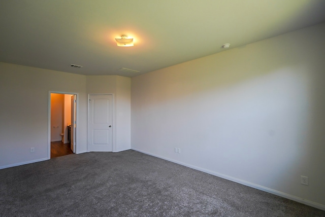 10314 White Fir Villa Ave, Houston, TX 77044 - unfurnished bedroom featuring dark colored carpet, baseboards, and connected bathroom