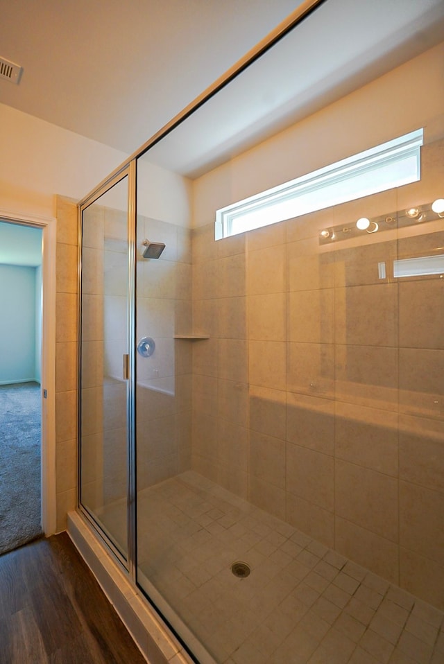 10314 White Fir Villa Ave, Houston, TX 77044 - bathroom featuring a stall shower and wood finished floors
