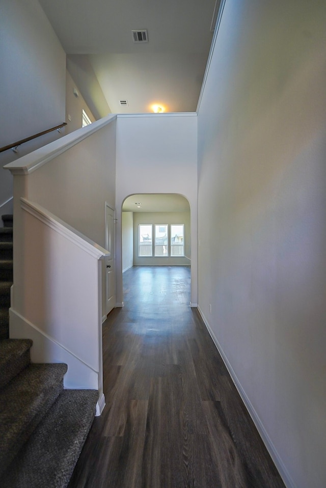10314 White Fir Villa Ave, Houston, TX 77044 - hallway with wood finished floors, arched walkways, stairway, and baseboards