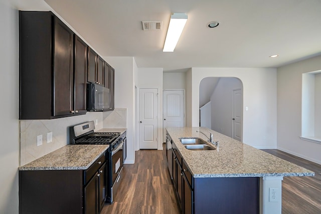 10314 White Fir Villa Ave, Houston, TX 77044 - kitchen featuring gas stove, a sink, dark wood finished floors, tasteful backsplash, and light stone counters