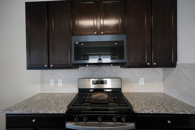10314 White Fir Villa Ave, Houston, TX 77044 - kitchen featuring stainless steel microwave, range with gas cooktop, backsplash, and light stone counters