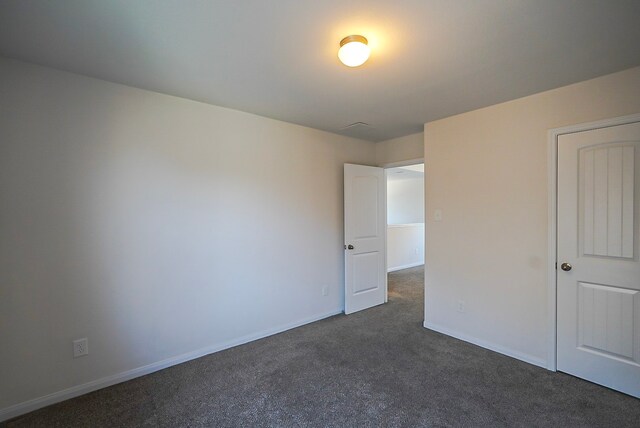 10314 White Fir Villa Ave, Houston, TX 77044 - unfurnished bedroom featuring dark colored carpet and baseboards