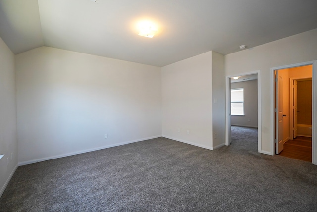 10314 White Fir Villa Ave, Houston, TX 77044 - empty room with dark carpet, baseboards, and lofted ceiling