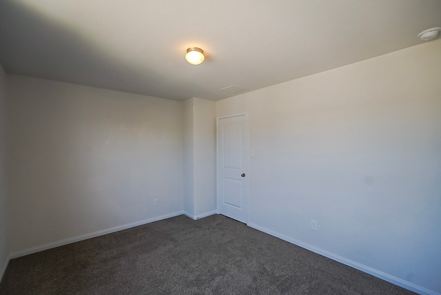 10314 White Fir Villa Ave, Houston, TX 77044 - spare room with dark colored carpet, a smoke detector, and baseboards