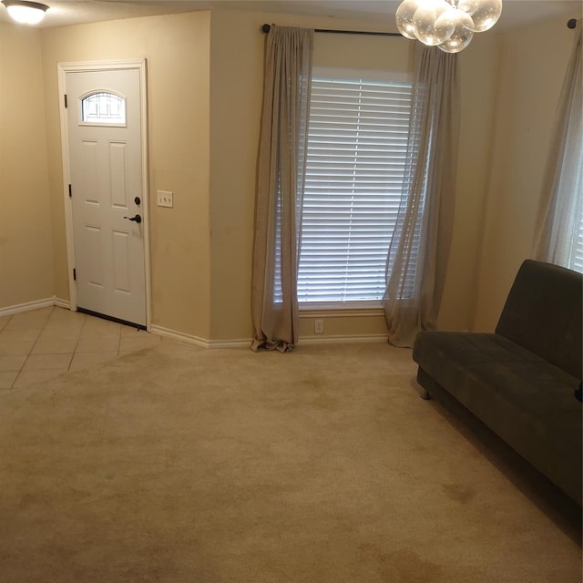 13564 Miller Ln, Willis, TX 77318 - foyer entrance with baseboards, a chandelier, light colored carpet, light tile patterned floors, and healthy amount of natural light