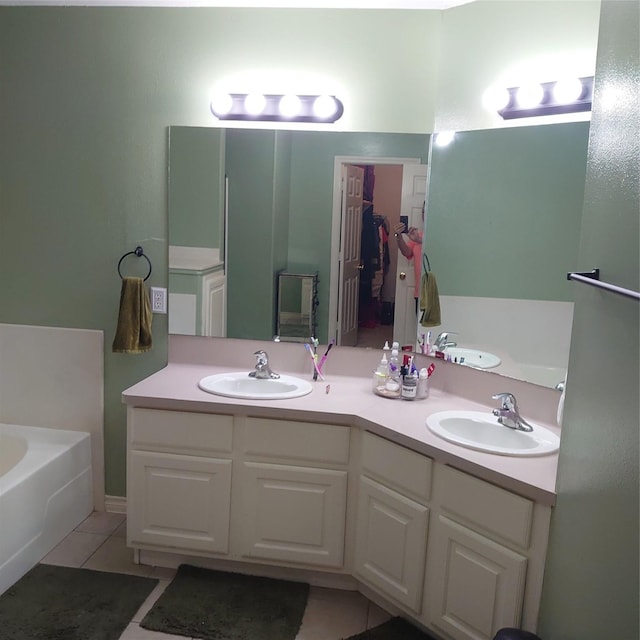 13564 Miller Ln, Willis, TX 77318 - bathroom with a bath, tile patterned flooring, and double vanity