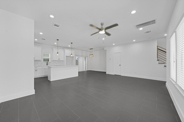 1513 Egypt St, Houston, TX 77009 - unfurnished living room with a ceiling fan, healthy amount of natural light, recessed lighting, and baseboards