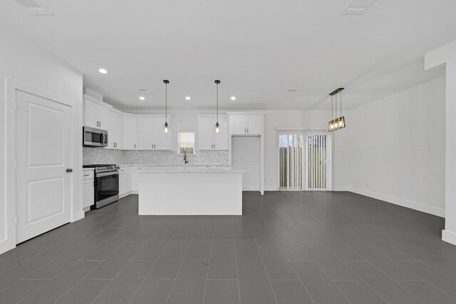 1513 Egypt St, Houston, TX 77009 - kitchen featuring stainless steel appliances, decorative backsplash, white cabinets, light countertops, and recessed lighting