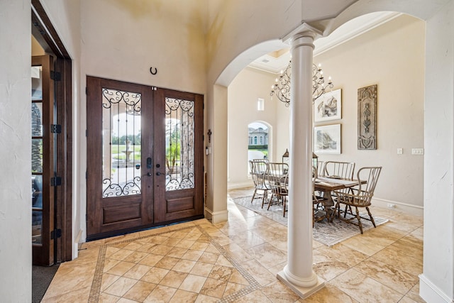 28802 Saddle Oak Dr, Conroe, TX 77356 - foyer entrance with french doors, baseboards, arched walkways, a high ceiling, and marble finish flooring
