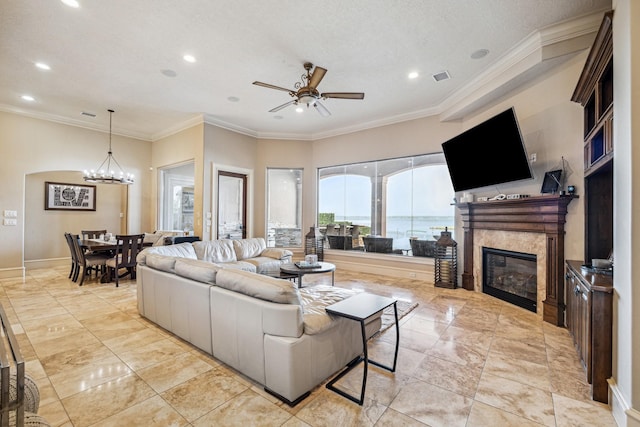 28802 Saddle Oak Dr, Conroe, TX 77356 - living area with a ceiling fan, recessed lighting, a glass covered fireplace, crown molding, and a chandelier