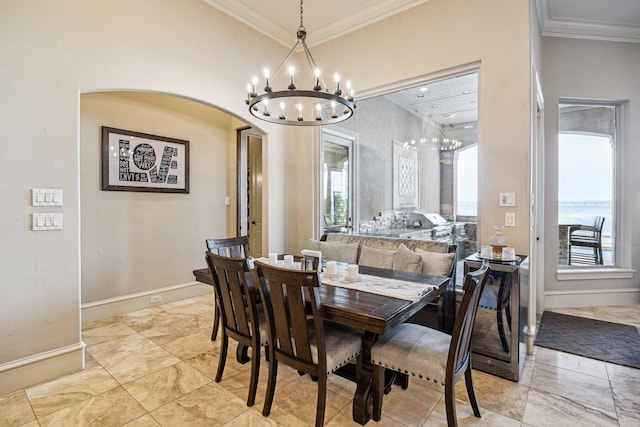 28802 Saddle Oak Dr, Conroe, TX 77356 - dining area featuring a chandelier, ornamental molding, healthy amount of natural light, arched walkways, and baseboards