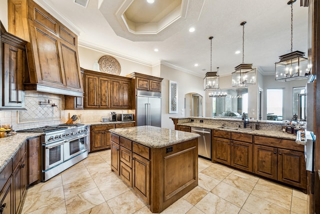 28802 Saddle Oak Dr, Conroe, TX 77356 - kitchen featuring premium appliances, a sink, crown molding, tasteful backsplash, and light stone countertops