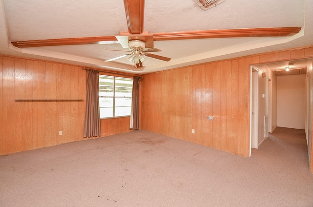 346 9th St, Hempstead, TX 77445 - carpeted empty room with wood walls, a ceiling fan, beamed ceiling, and attic access