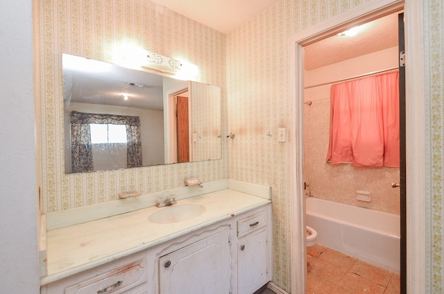 346 9th St, Hempstead, TX 77445 - bathroom with vanity, toilet, wallpapered walls, and tub / shower combination