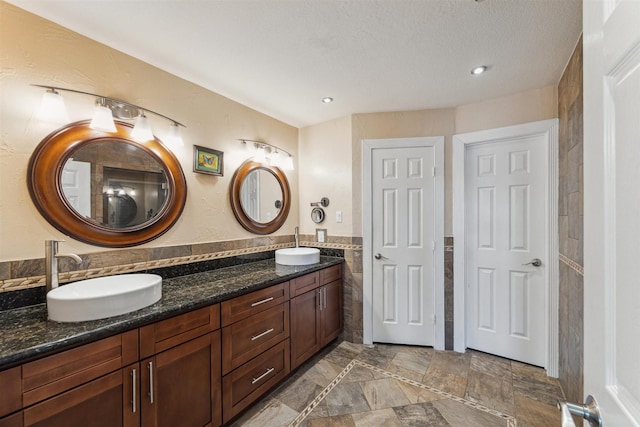 1022 Long Reach Dr, Tiki Island, TX 77554 - bathroom featuring tile walls, double vanity, and recessed lighting