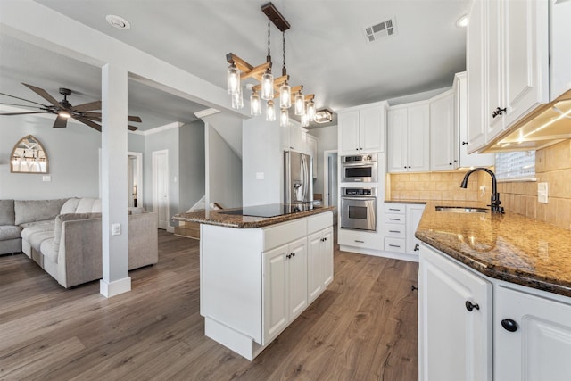 1022 Long Reach Dr, Tiki Island, TX 77554 - kitchen with a sink, appliances with stainless steel finishes, open floor plan, a ceiling fan, and white cabinets