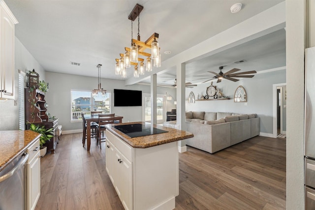 1022 Long Reach Dr, Tiki Island, TX 77554 - kitchen featuring black electric cooktop, a ceiling fan, a kitchen island, a chandelier, and stainless steel dishwasher