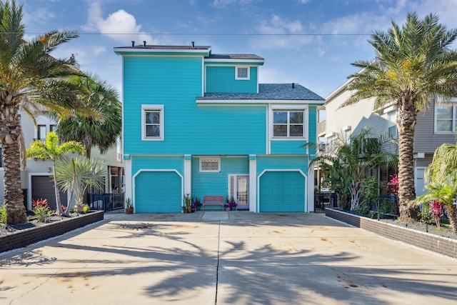1022 Long Reach Dr, Tiki Island, TX 77554 - view of front facade with an attached garage and driveway