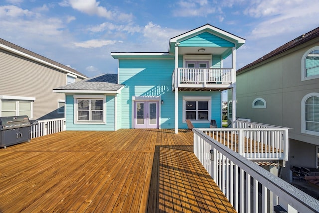 1022 Long Reach Dr, Tiki Island, TX 77554 - rear view of house with a balcony, french doors, a wooden deck, and a shingled roof