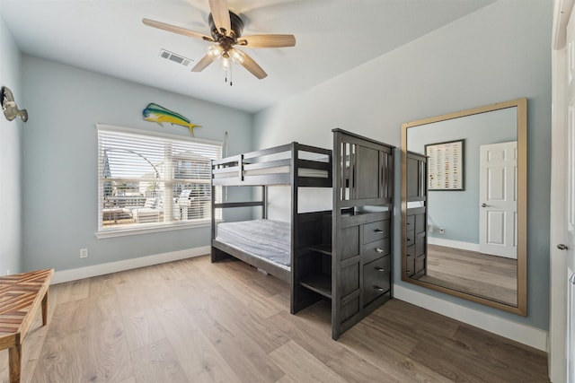 1022 Long Reach Dr, Tiki Island, TX 77554 - bedroom with baseboards, wood finished floors, and ceiling fan