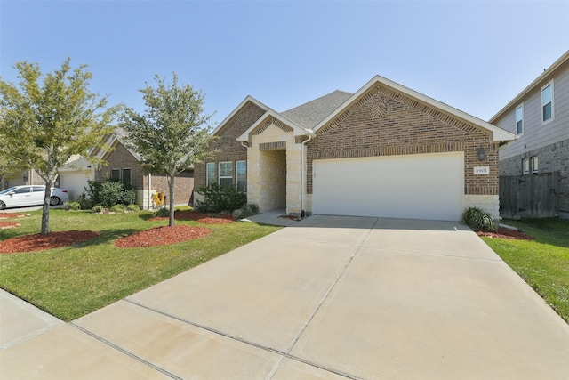 8902 Jasper Lake Dr, Cypress, TX 77433 - view of front facade featuring an attached garage, concrete driveway, brick siding, and stone siding