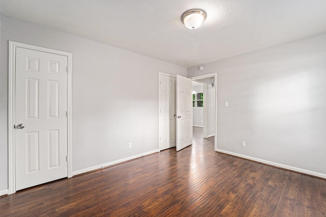 7433 Yoe St, Houston, TX 77016 - unfurnished bedroom with baseboards and dark wood-style flooring