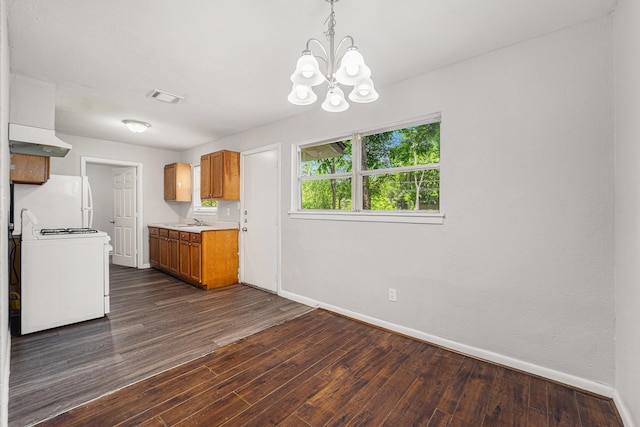 7433 Yoe St, Houston, TX 77016 - kitchen featuring stove, baseboards, brown cabinets, under cabinet range hood, and dark wood-style floors