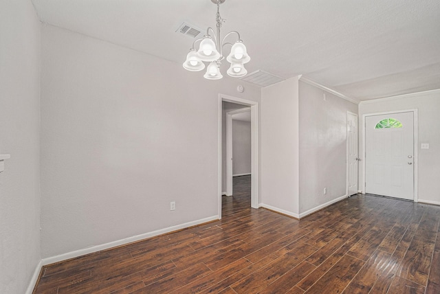 7433 Yoe St, Houston, TX 77016 - empty room featuring a chandelier, dark wood-style floors, baseboards, and ornamental molding